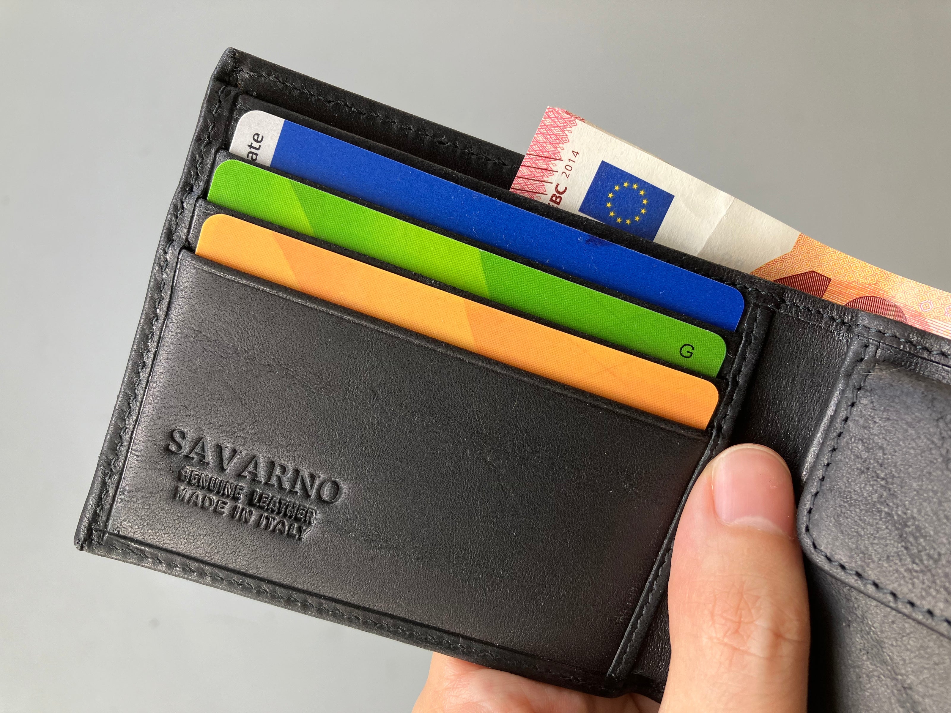 Savarno classic black bi-fold wallet pictured with cards and cash